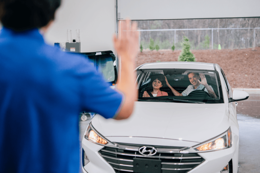 Happy customer receiving repaired car after auto glass service in Cedar Park Texas