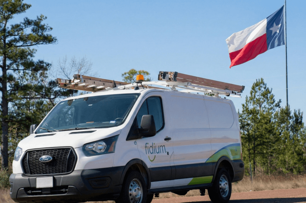 fidium truck with Texas flag behind it