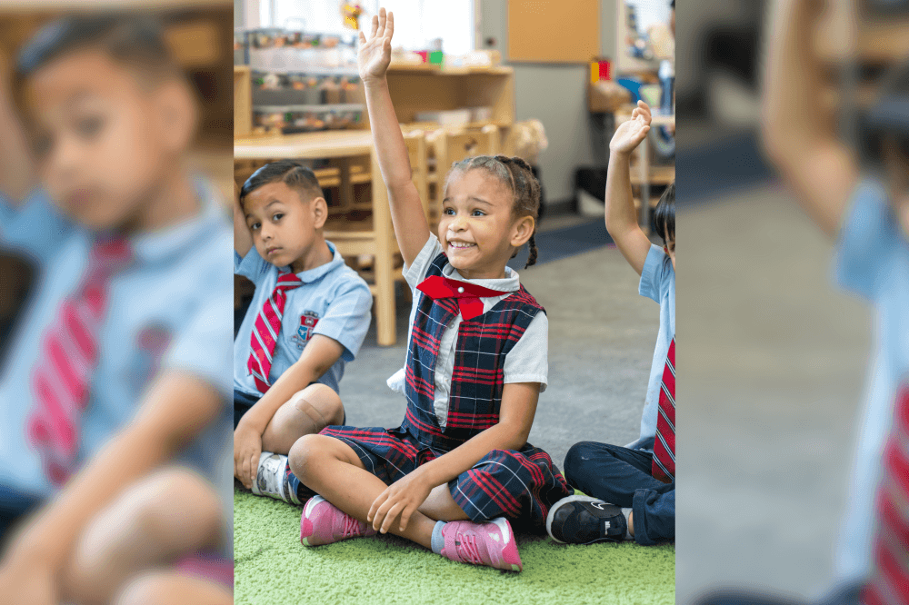 child raising her hand in class