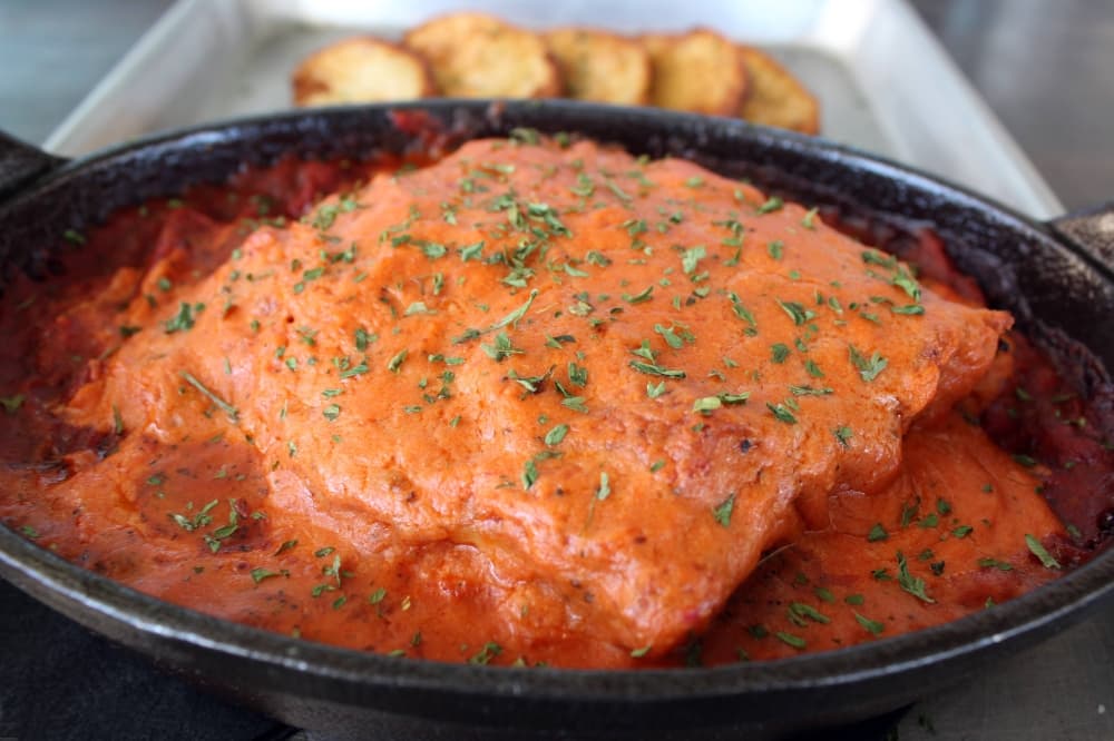 Lasagna in a black dish. 