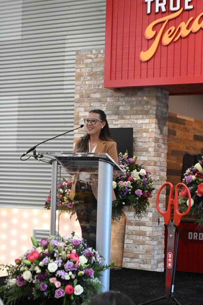 Tory Adams, the store leader for the new H-E-B, speaks at a ribbon cutting event May 19.