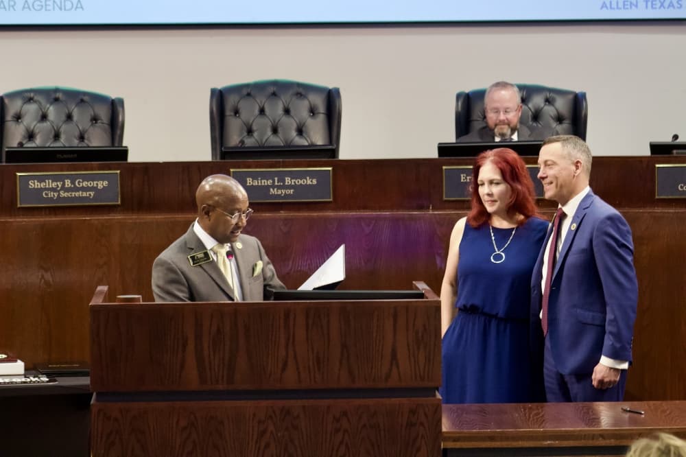 people standing behind a podium at a meeting