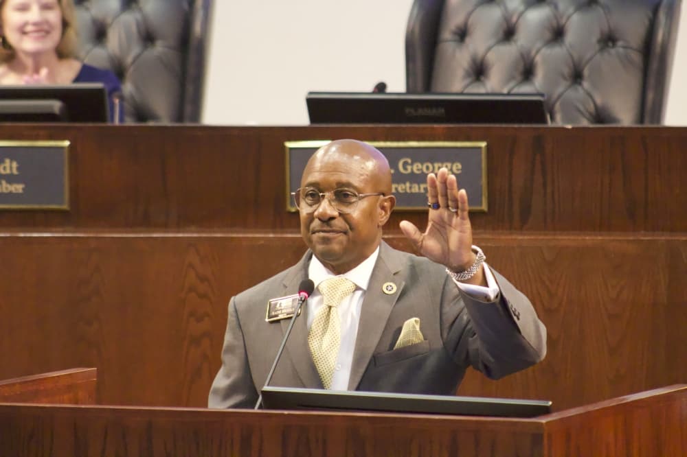 Baine Brooks standing behind a podium