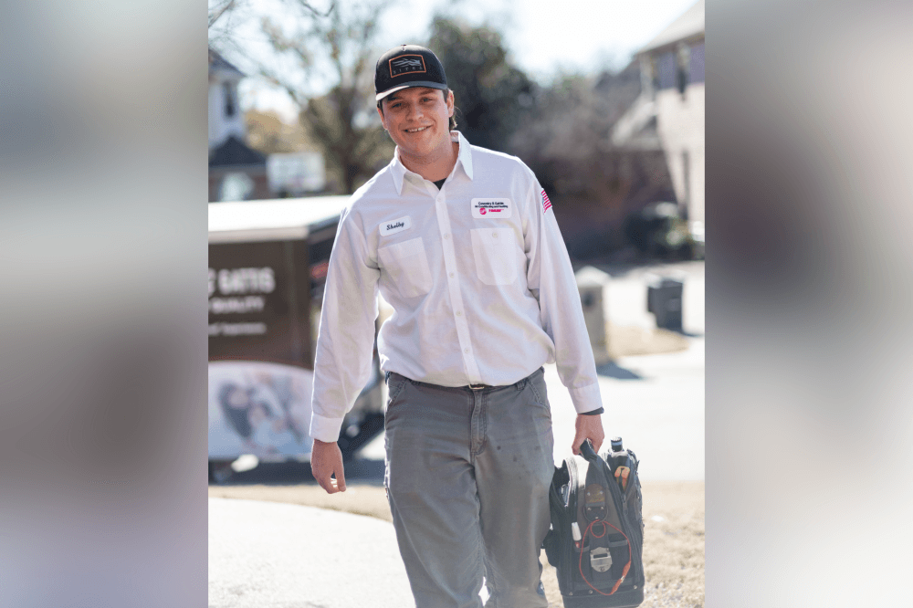 HVAC technician performing air conditioning maintenance and system inspection for a homeowner in Grapevine, Texas.