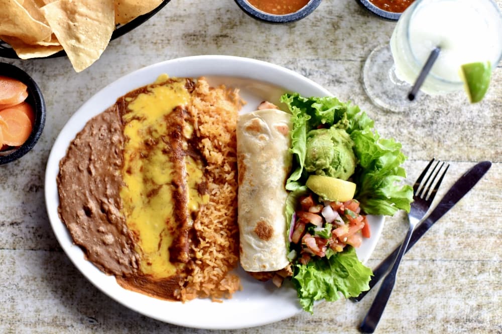 The C.W. Special ($16.95) is a lunch special and includes a taco al carbon, a cheese enchilada, rice and beans, pico de gallo and guacamole and is served with chili con queso. (Courtesy Molina's Cantina)