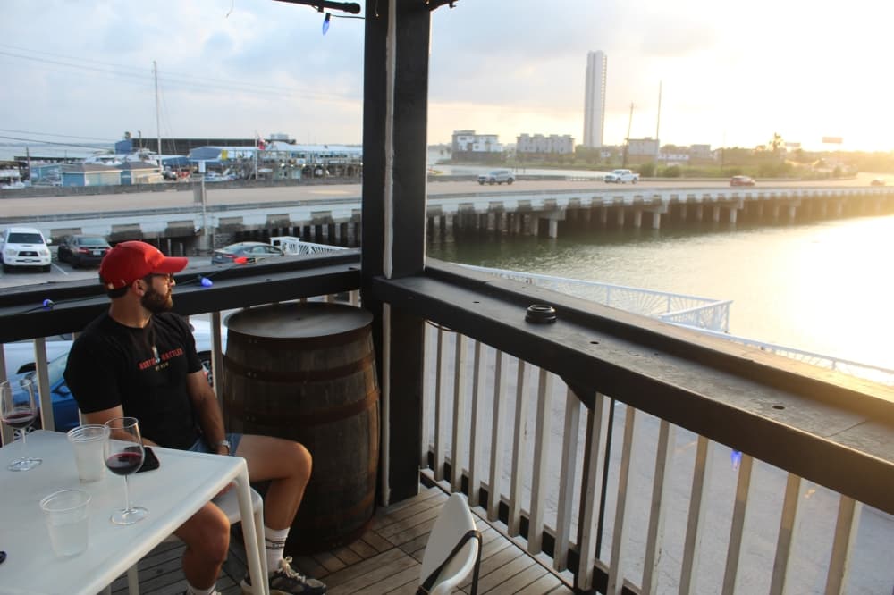 The two-story bar and its attached patios overlook Taylor Lake, where guests can catch a sunset while enjoying a glass of wine with over 100 options to choose from. (Rachel Leland/Community Impact)