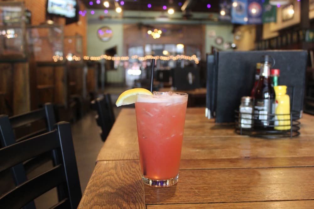 A pink drink with a lemon