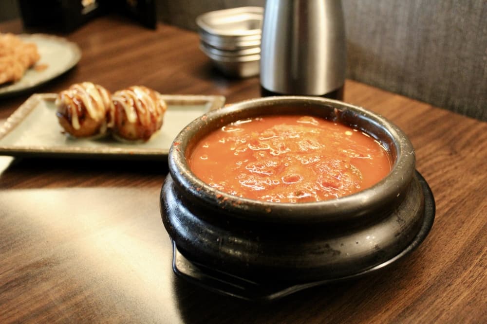 The kimchi soup is amongst the hot sides customers can select from. (Jovanna Aguilar/Community Impact)