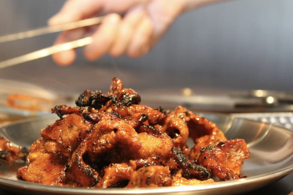The spicy pork bulgogi is amongst the premium meat served at Gangnam BBQ & Sushi. (Jovanna Aguilar/Community Impact)