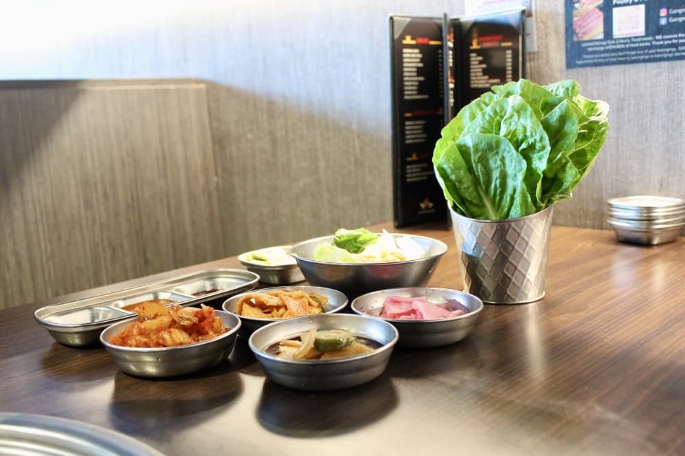 All-you-can-eat services include a variety of small Korean side dishes. (Jovanna Aguilar/Community Impact)
