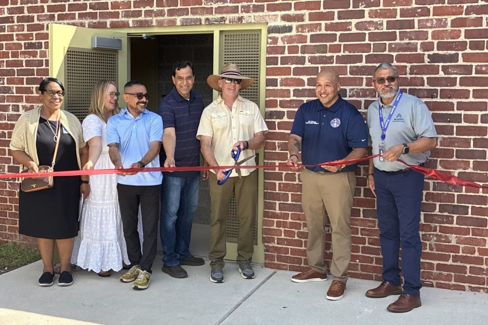 Austin Parks and Recreation department officials, community members and local artist Samson Barboza attended the ribbon-cutting for the renovated Parque Zaragoza Recreation Center bathhouse in East Austin on June 20. (Jessica McLaren/Community Impact)