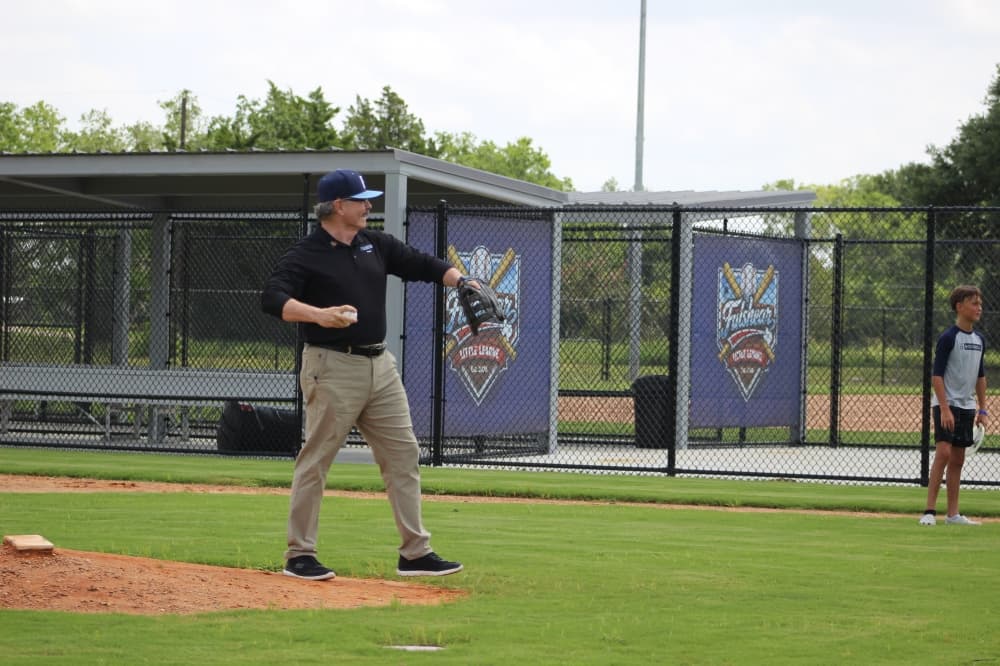 Fulshear Mayor Don McCoy threw the first ceremonial pitch to welcome residents to the new ball fields. (Aubrey Howell/Community Impact)