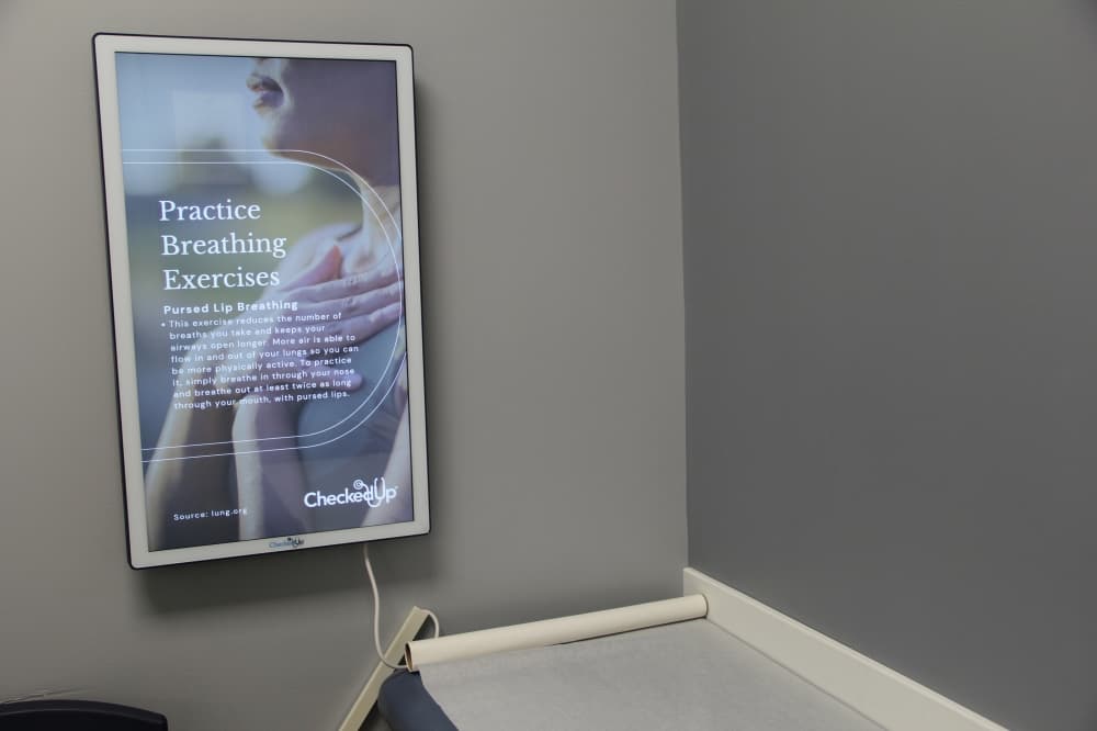 In several of WeeKare Pediatric's patient rooms, parents and children have access to interactive screens with various educational resources and tips. (Wesley Gardner/Community Impact)