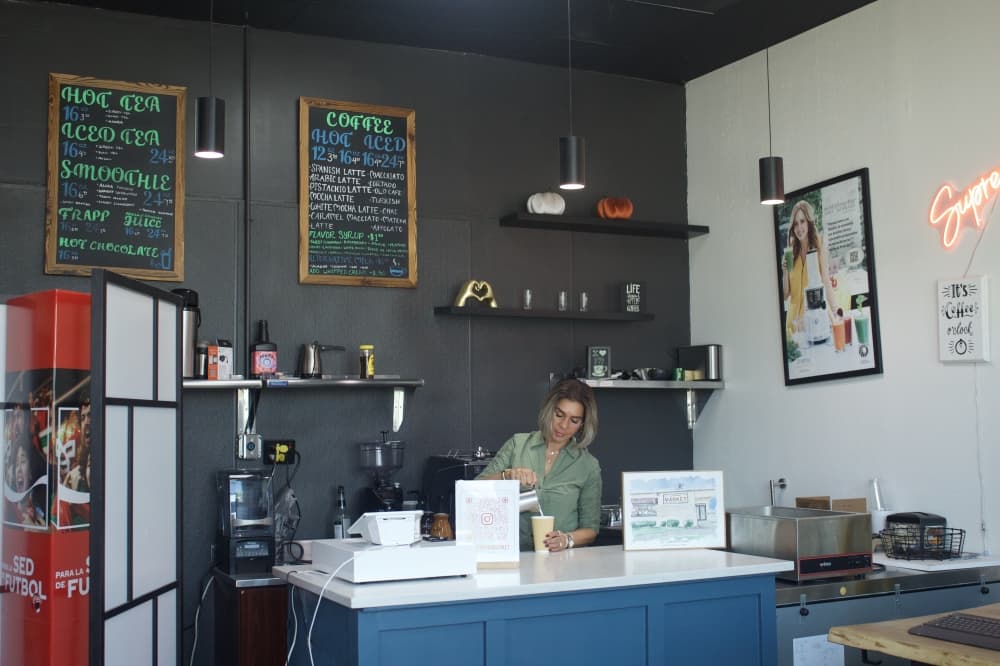 Summer Bannat making a coffee behind a counter