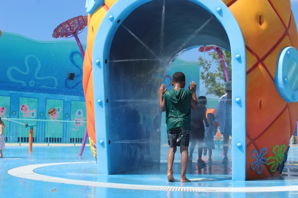 Children run through a splash pad at Universal Kids Resort in Frisco within the SpongeBob SquarePants Bikini Bottom land on June 18. (Samantha Douty/Community Impact)
