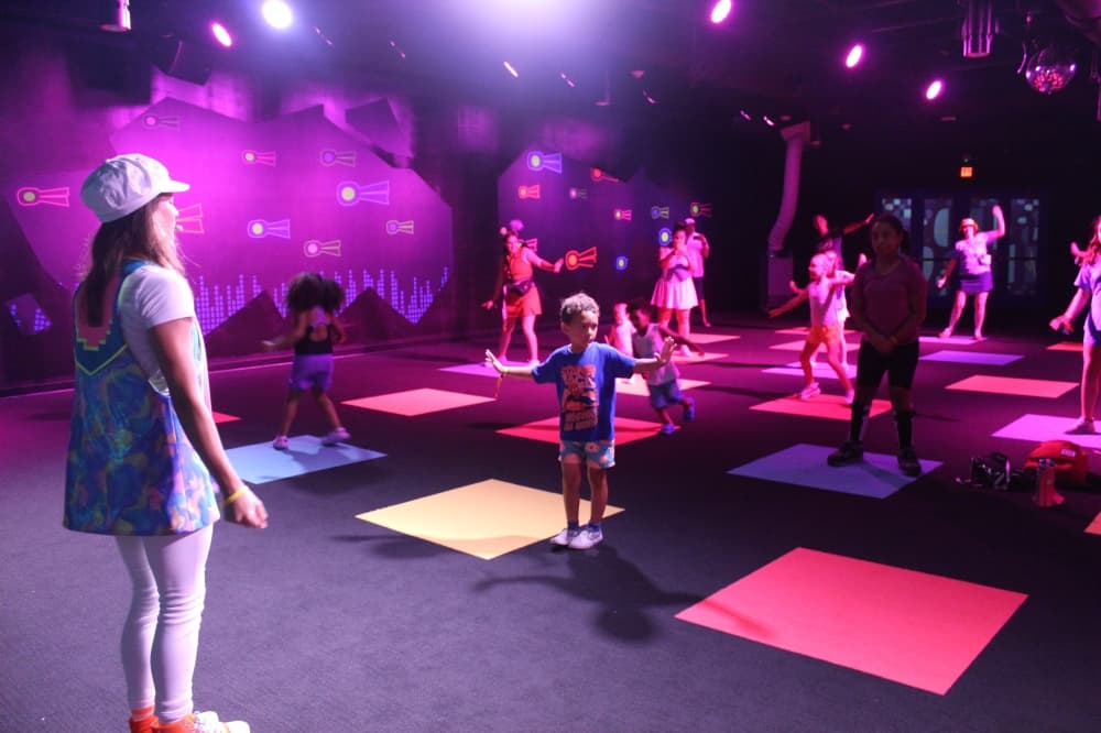 Young parkgoers dance at King Trollex Techno Dance Party at TrollsFest at Universal Kids Resort in Frisco. TrollsFest is one of seven themed lands at the park, which opens officially on July 1. (Samantha Douty/Community Impact)