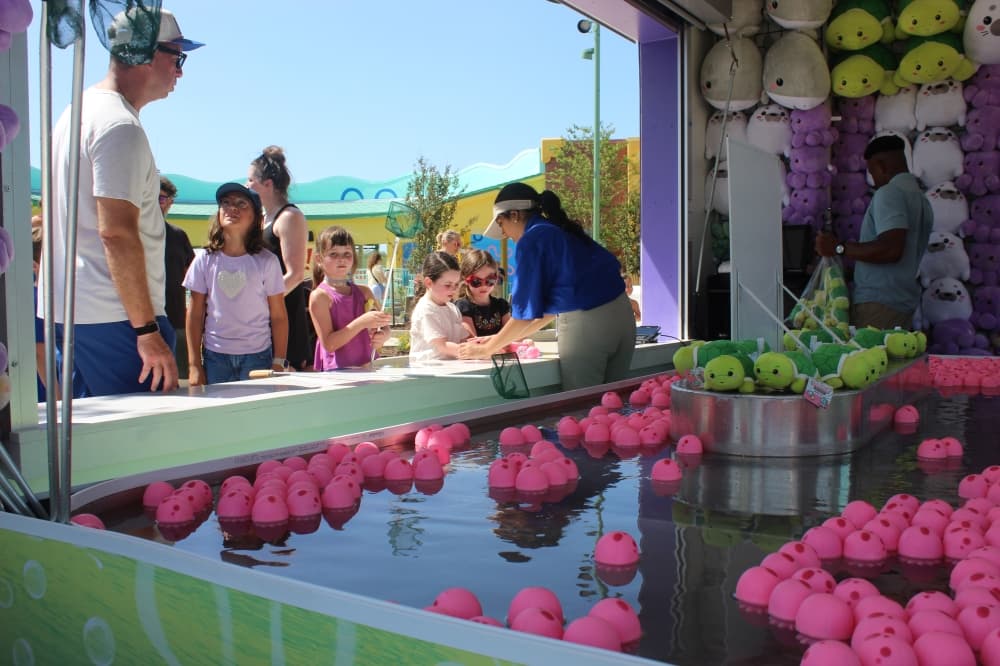 Children play a park game where they catch jelly fish for a prize at Universal Kids Resort in Frisco on June 18. (Samantha Douty/Community Impact)