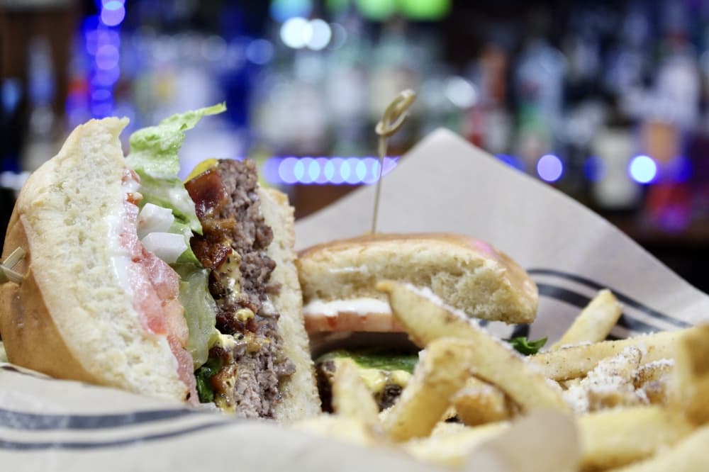 The classic burger ($13.99-$14.55) includes lettuce, onions, tomatoes, pickles and mayo. (Jovanna Aguilar/Community Impact)