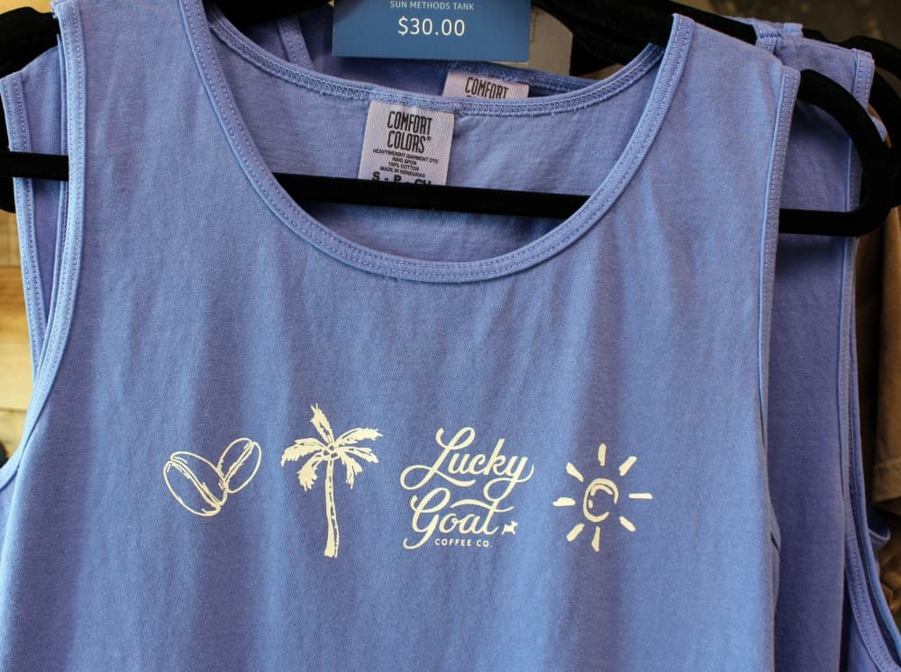  Branded merchandise, including shirts, are sold at Lucky Goat Coffee Co. in Frisco. (Karen Chaney/Community Impact)