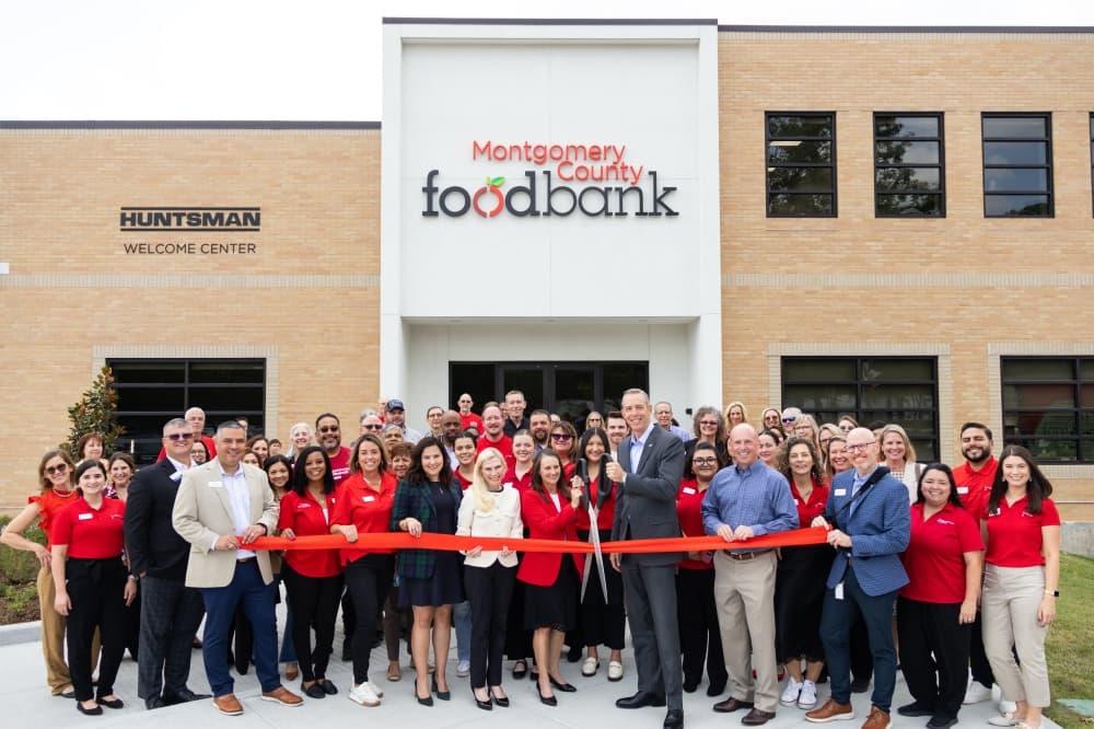 A group of people at a ribbon cutting