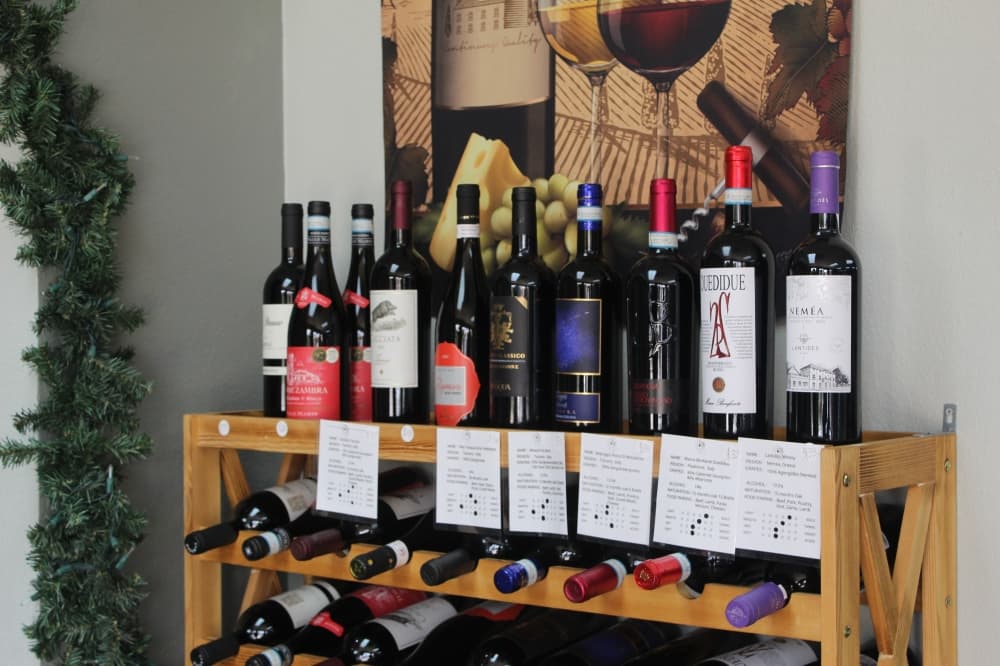 Bottles of wine displayed on a wooden shelf