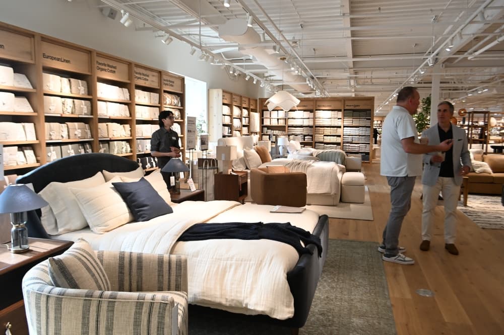 Customers talk near a bedroom display within Southlake's Crate & Barrel.