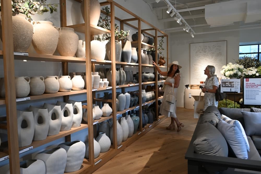 Customers shop within the floral section of Crate & Barrel.