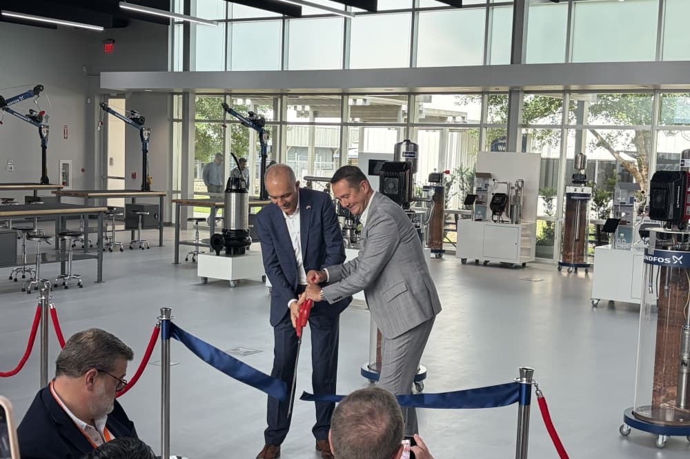 Grundfos executives Hamed Heyhat (left) and Bent Jensen (right) cut the ribbon to open its new Academy Americas training center. (Brad Dountz/Community Impact)