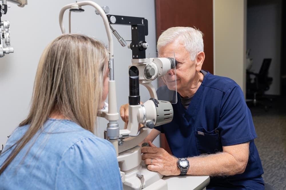 dr. ryne examining patient's eyes