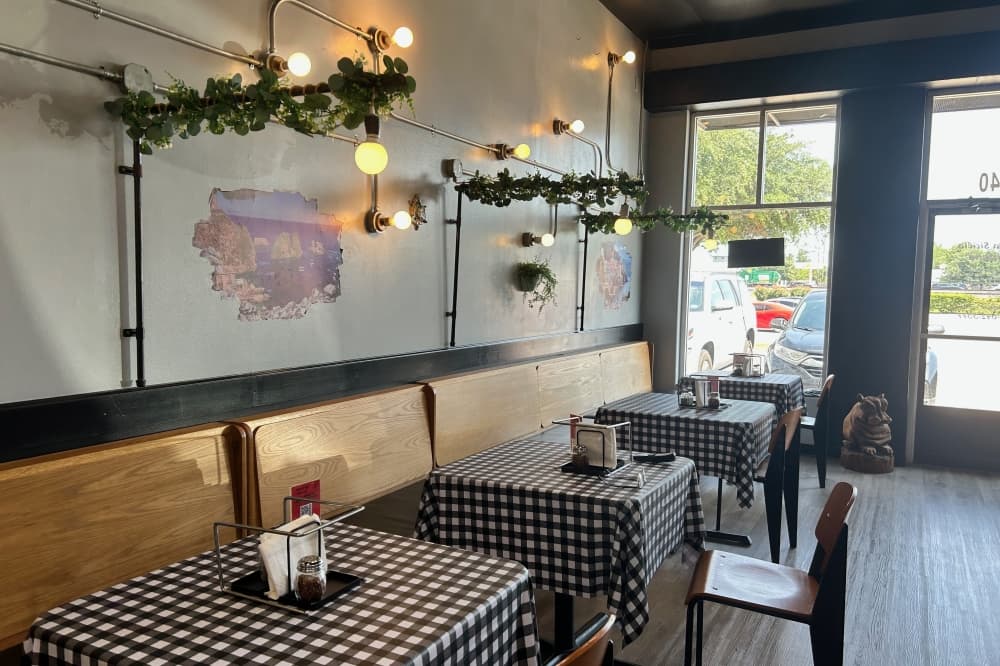 The restaurant's interior includes scenes from Sicily. (Brooke Sjoberg/Community Impact)