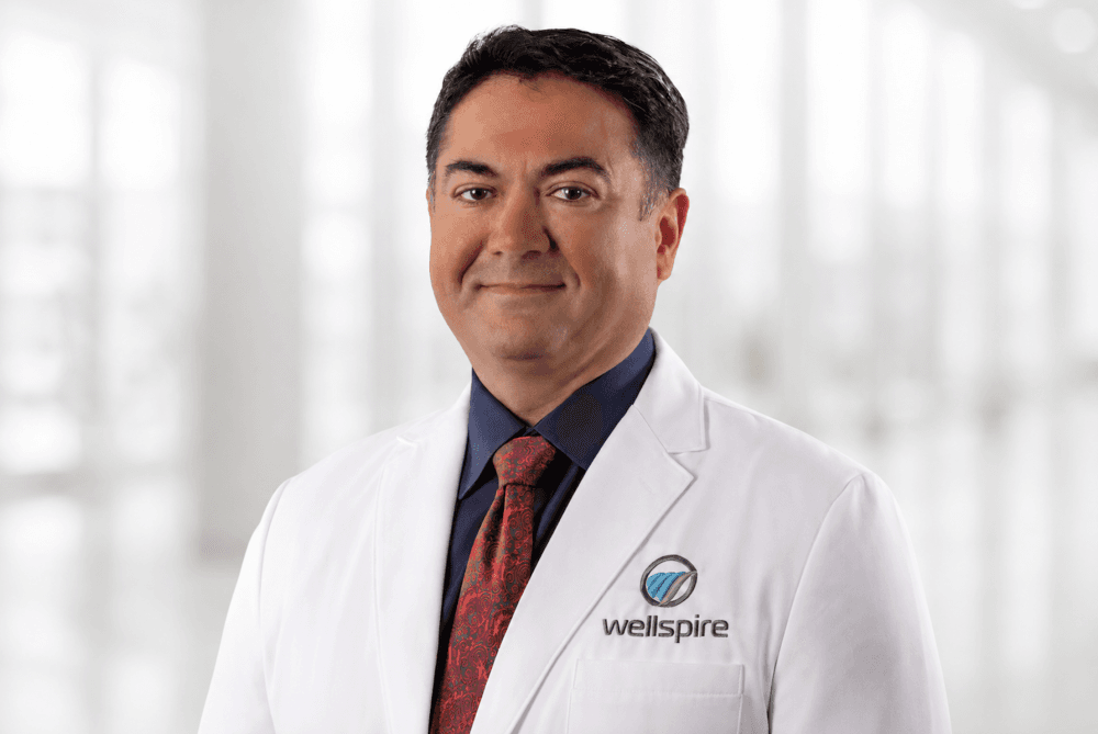 Primary care physician at Wellspire Medical Houston collaborating with multi-specialty care team using shared electronic medical records