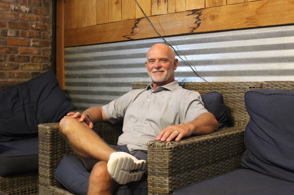 A man sitting with one leg crossed over the other