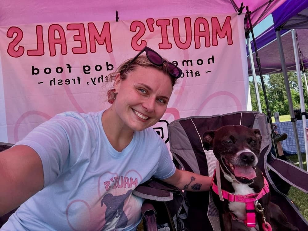 Rebecca Balaskovits and Maui posing for a photo