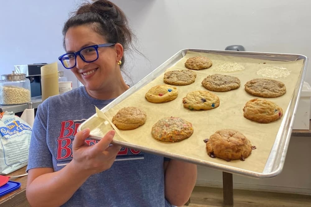 Leslie Perkins holding baking sheet with cookies 