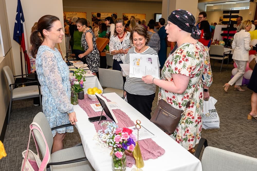 people discuss materials at an event table