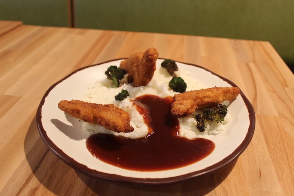 At Jurassic World Canteern Dinosaur Bites are available and it features baked mega-dino chicken nuggets on an active mashed potato volcano with lava BBQ sauce and broccoli. (Samantha Douty/Community Impact)