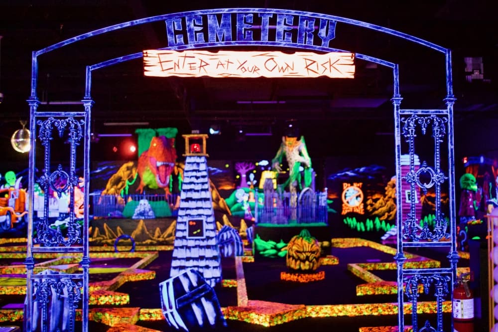 Monster Mini Golf's course is illuminated with black lights and features 18 holes of horror- and monster-themed golf. (Jennifer Siciliano/Community Impact)