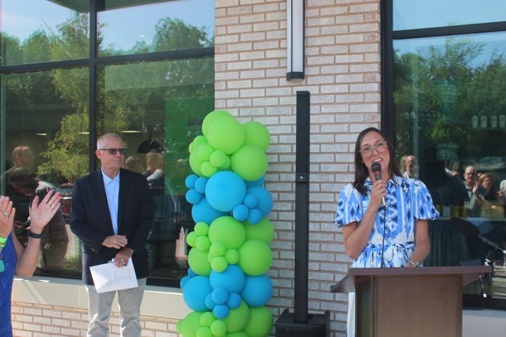 Hugs Cafe Inc. CEO Lauren Smith speaks during a ribbon cutting ceremony for the new Hugs Cafe Inc. headquarters.