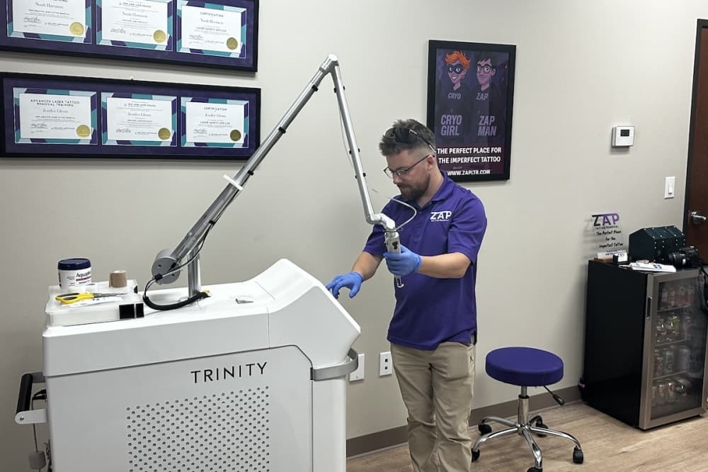 Harmon adjusts the settings on ZAP's laser tattoo removal machine. (Michael Crouchley/Community Impact)