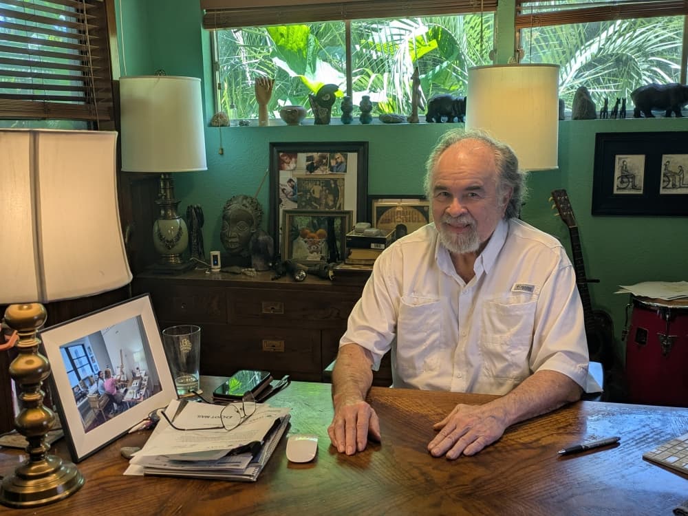 man in white shirt at desk