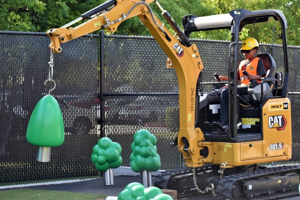 Excavator hooking up a tree
