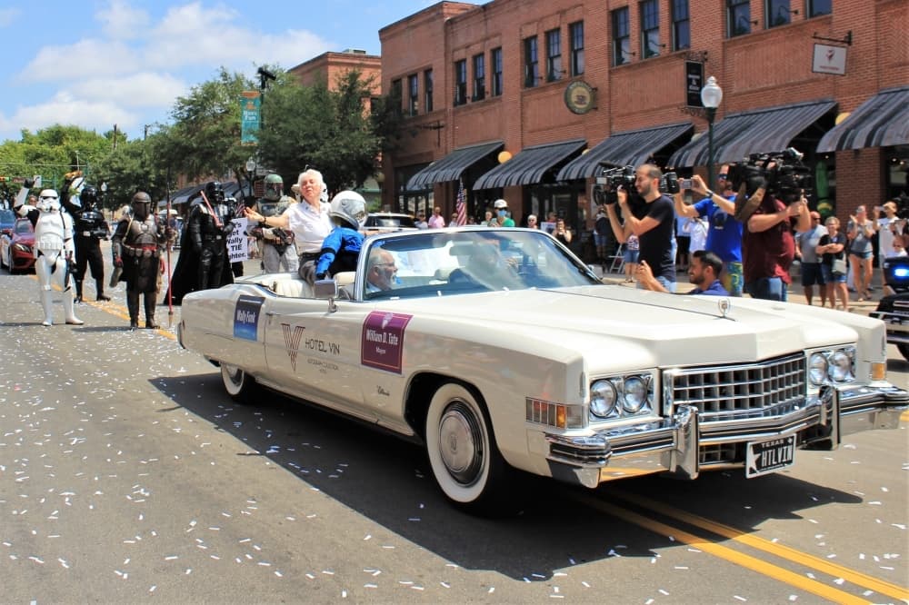 Wally Funk rides in a vehicle during a celebration of her historic space flight.