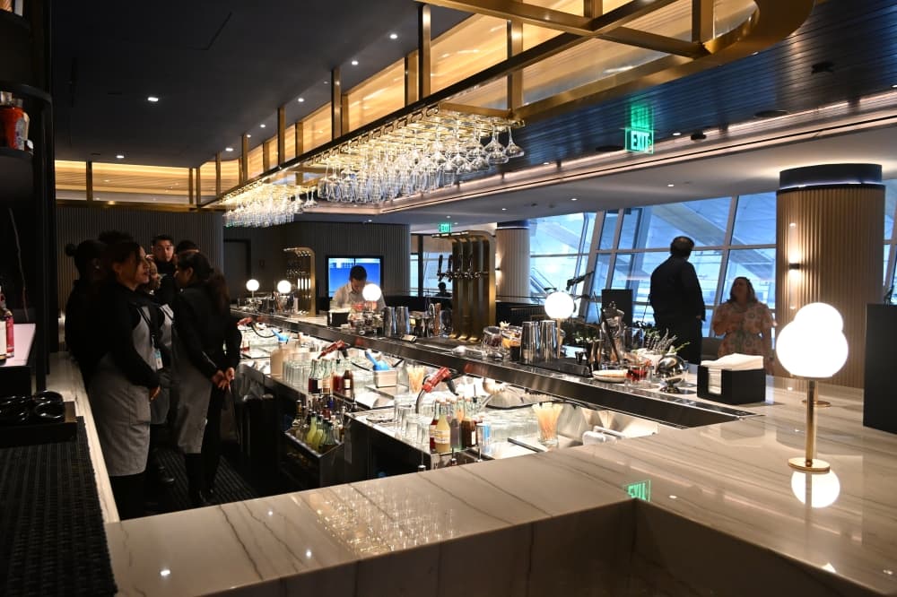 A bar area within the lounge has a selection of beers and cocktails. 