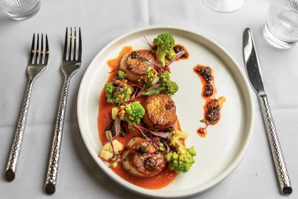 A hors d'oeuvres, the Hokkaido scallops ($34) are prepared with a red pepper coulis, romanesco and salsa macha. (Courtesy Sovian Restaurant and Cocktail Lounge) 