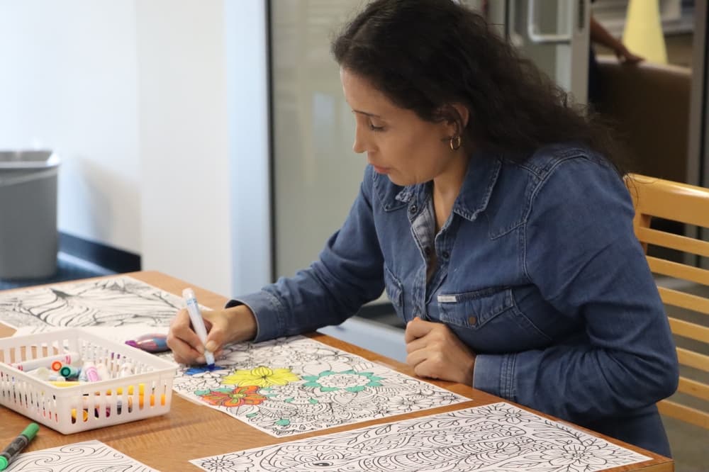 woman coloring at the bastrop public library