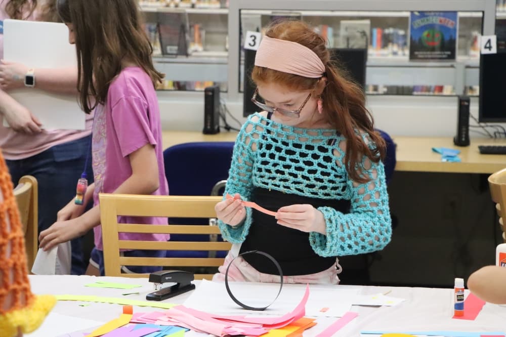 child crocheting at the bastrop public library