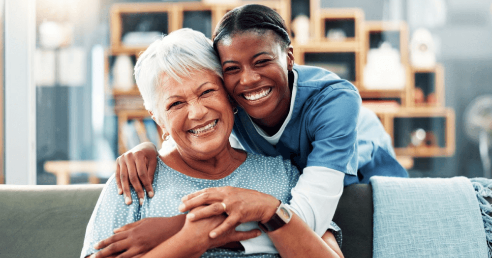 caregiver smiling with senior citizen