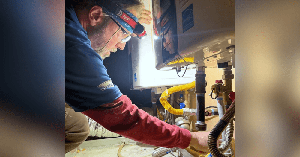 HVAC technician repairing an air conditioning system for a homeowner in Round Rock, Texas
