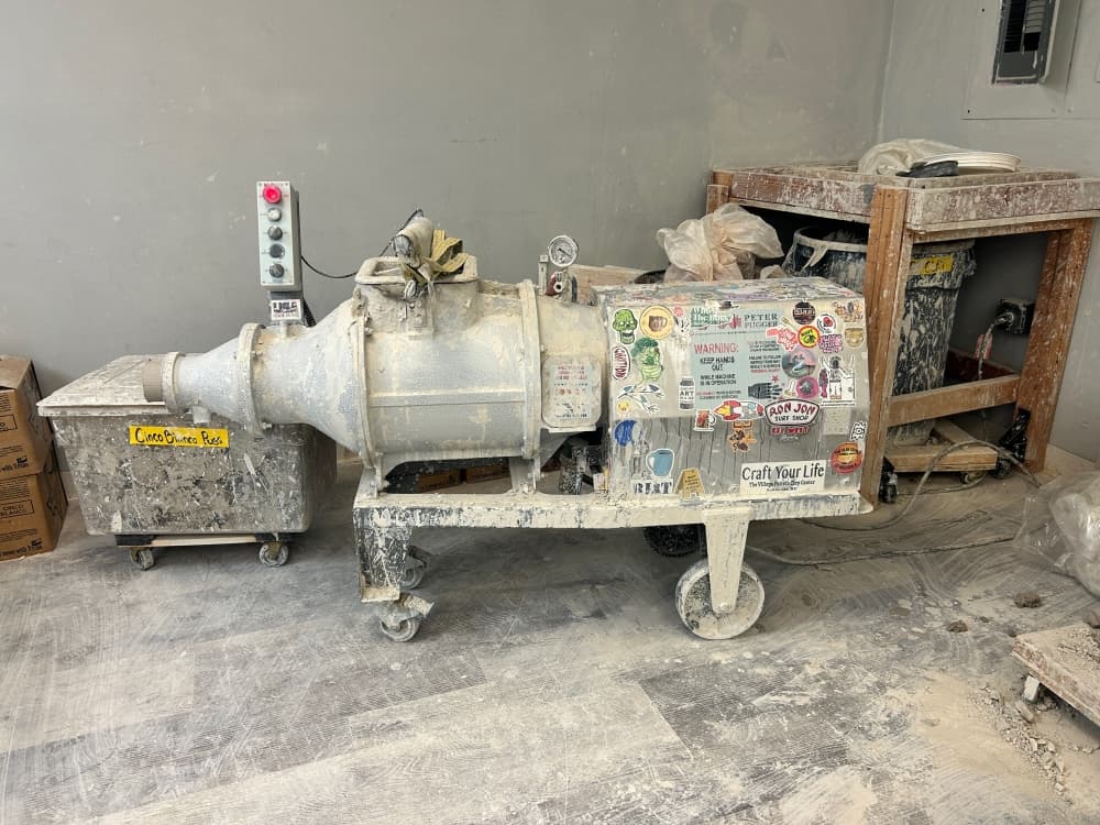 The pottery studio goes through about 2,000 pounds of clay per month, sourced locally from Austin-based Armadillo Clay & Supply Co. Extra clay and unfired pieces are recycled using a pugmill (pictured). (Brooke Sjoberg/Community Impact)