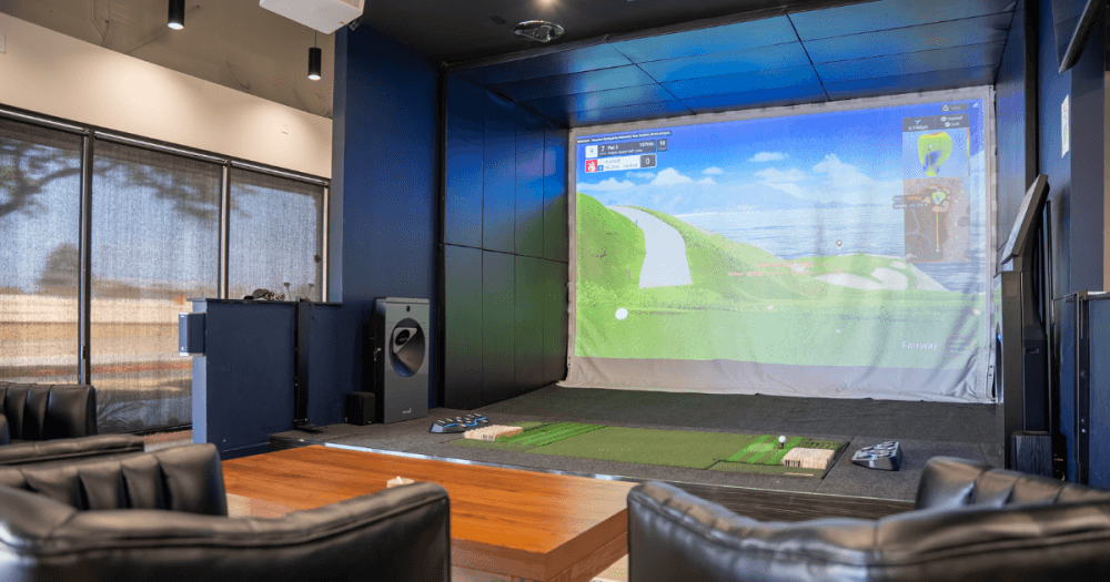 Indoor golf simulator at 2-1-Fore Golf featuring Golfzon technology, automatic tee system and climate-controlled playing bay.